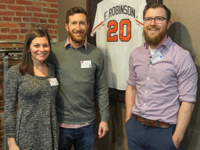 Alex, Aaron and Zach around Frank Robinson's jersey